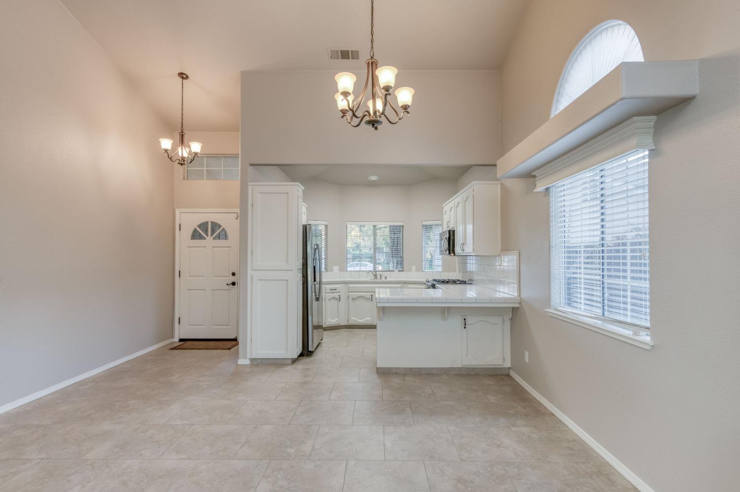 2365 Fallbrook Avenue Clovis, CA 93611 - Photo 15 of 42 a very nice looking dining room with chandelier fan and windows