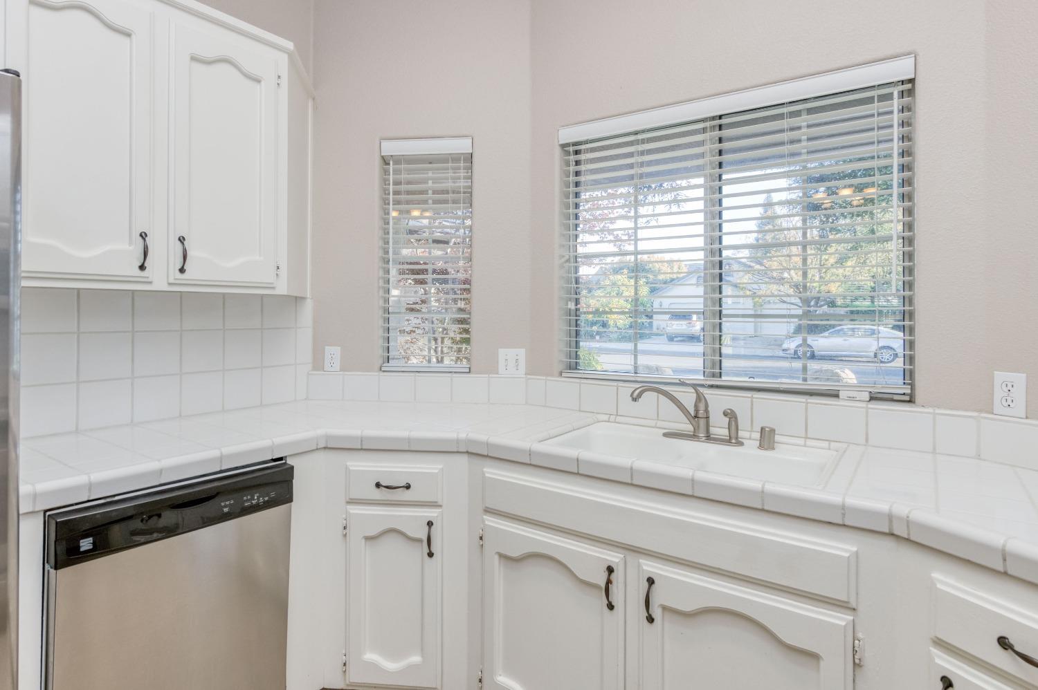 2365 Fallbrook Avenue Clovis, CA 93611 - Photo 17 of 42 a kitchen with stainless steel appliances white cabinets and a window