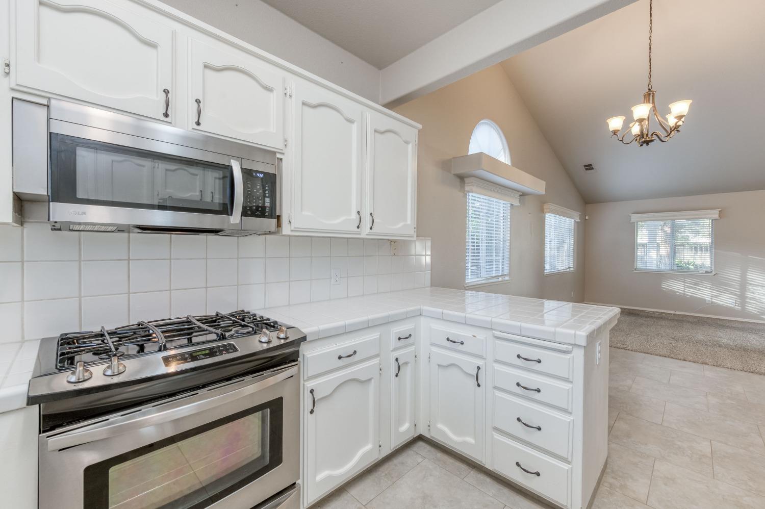 2365 Fallbrook Avenue Clovis, CA 93611 - Photo 18 of 42 a kitchen with cabinets stainless steel appliances and window