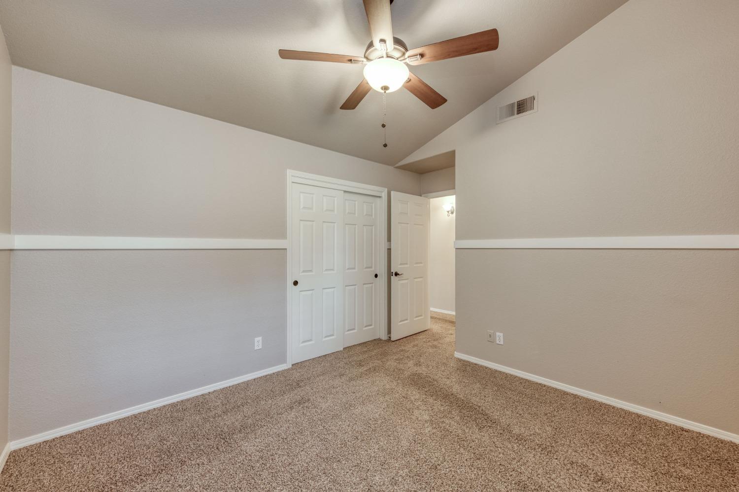 2365 Fallbrook Avenue Clovis, CA 93611 - Photo 20 of 42 an empty room with a ceiling fan and kitchen view