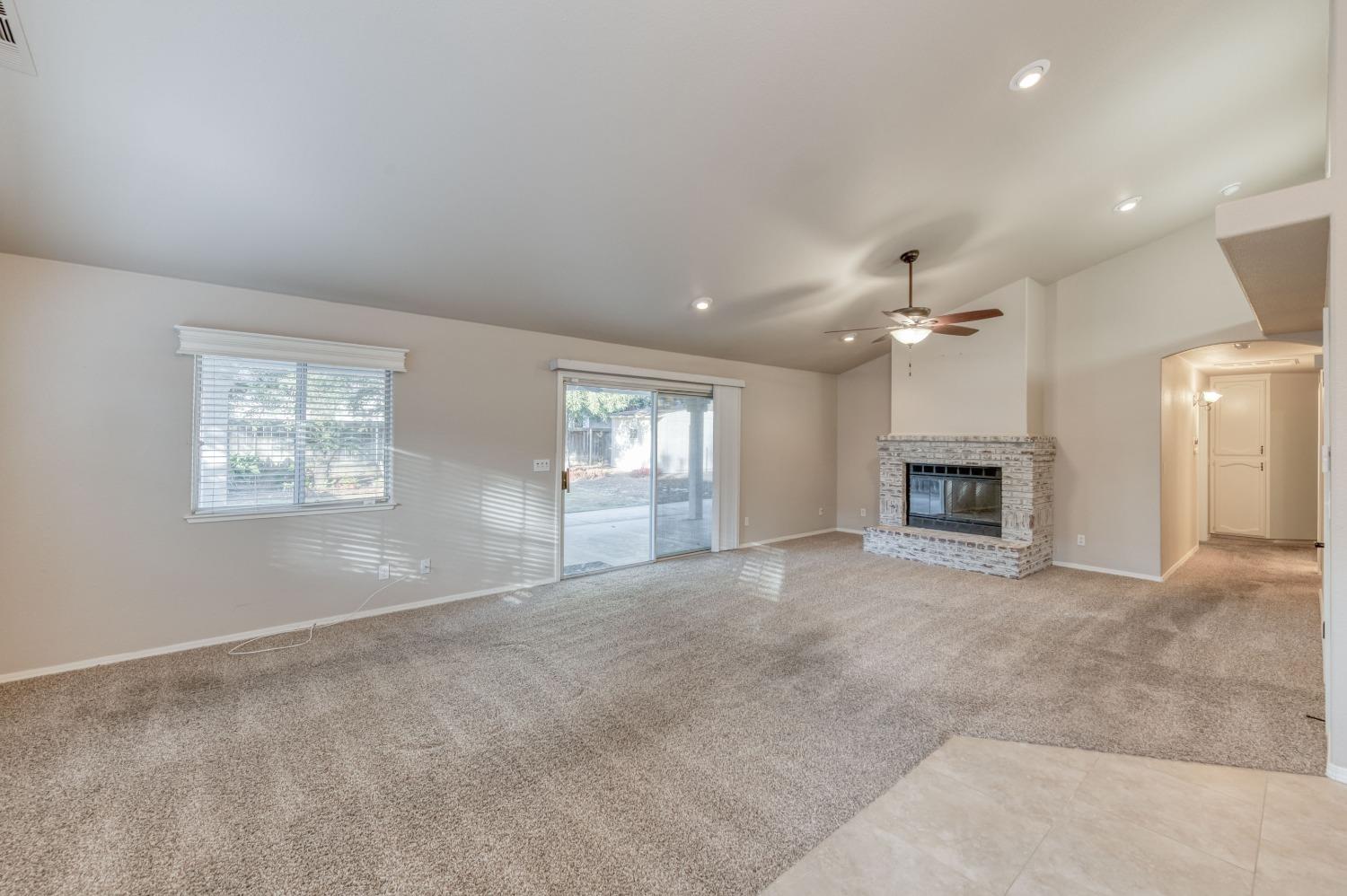 2365 Fallbrook Avenue Clovis, CA 93611 - Photo 2 of 42 an empty room with windows and fireplace
