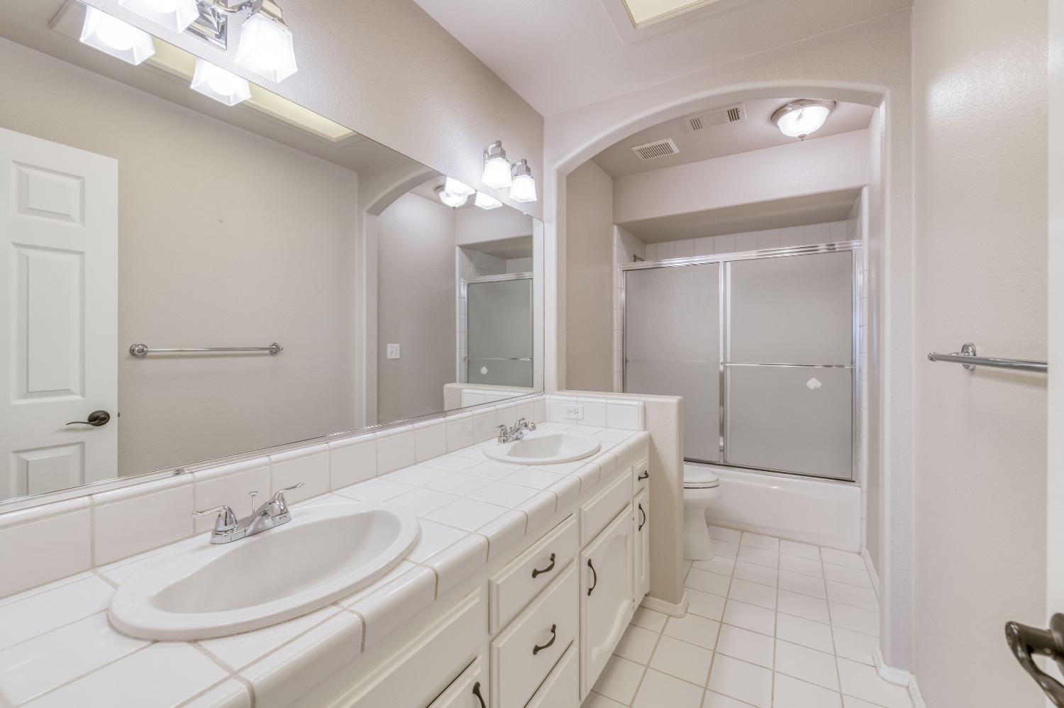 2365 Fallbrook Avenue Clovis, CA 93611 - Photo 22 of 42 a bathroom with a double vanity sink mirror and double