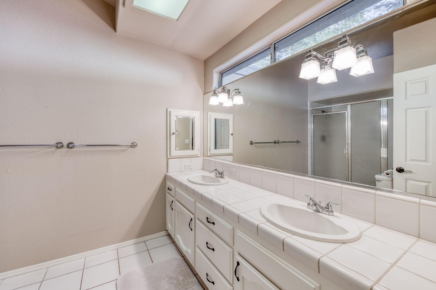 2365 Fallbrook Avenue Clovis, CA 93611 - Photo 27 of 42 a bathroom with a double vanity sink and a mirror