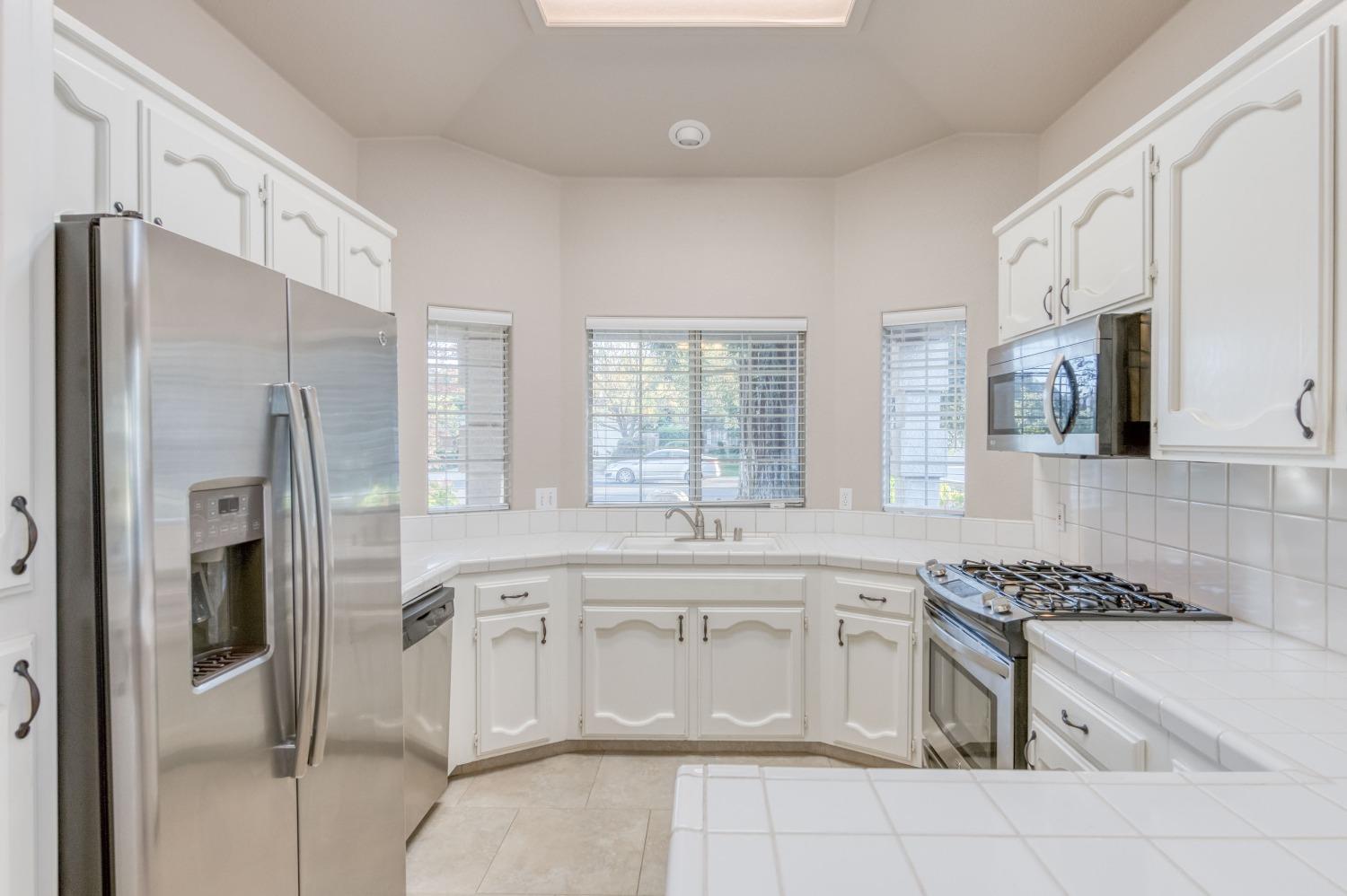 2365 Fallbrook Avenue Clovis, CA 93611 - Photo 3 of 42 a kitchen with stainless steel appliances granite countertop a stove a sink and a refrigerator
