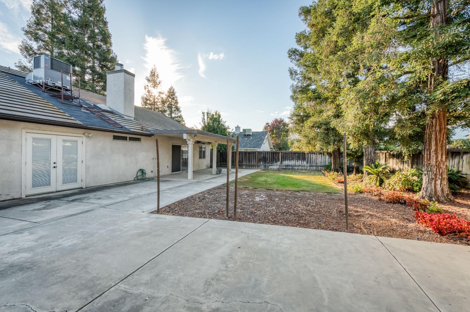 2365 Fallbrook Avenue Clovis, CA 93611 - Photo 35 of 42 a view of a house with a backyard and a tree