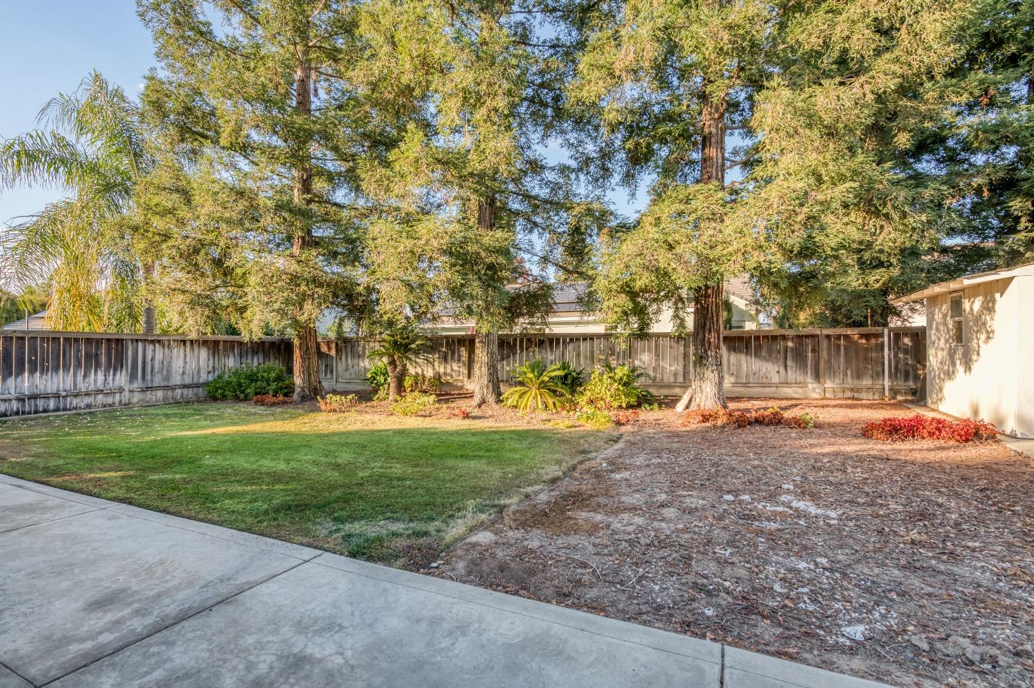 2365 Fallbrook Avenue Clovis, CA 93611 - Photo 40 of 42 a backyard of a house with fountain and outdoor seating