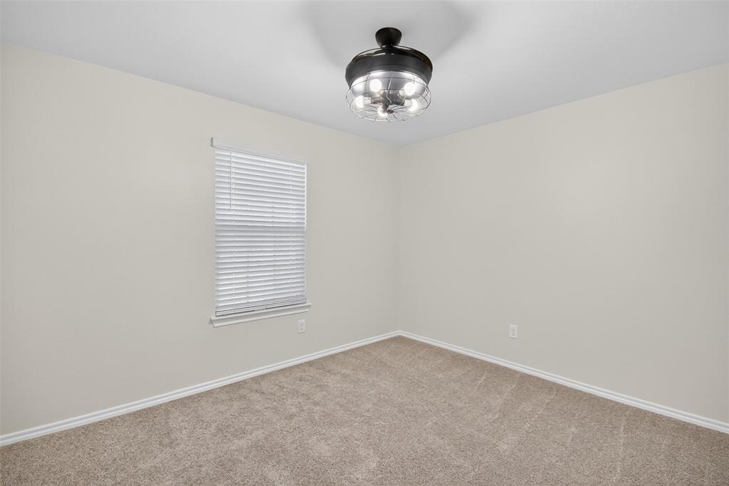 827 Rustic Way Royse City, TX 75189 - Photo 13 of 32 an empty room with a chandelier fan