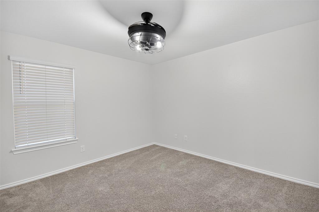 827 Rustic Way Royse City, TX 75189 - Photo 21 of 32 an empty room with a chandelier fan