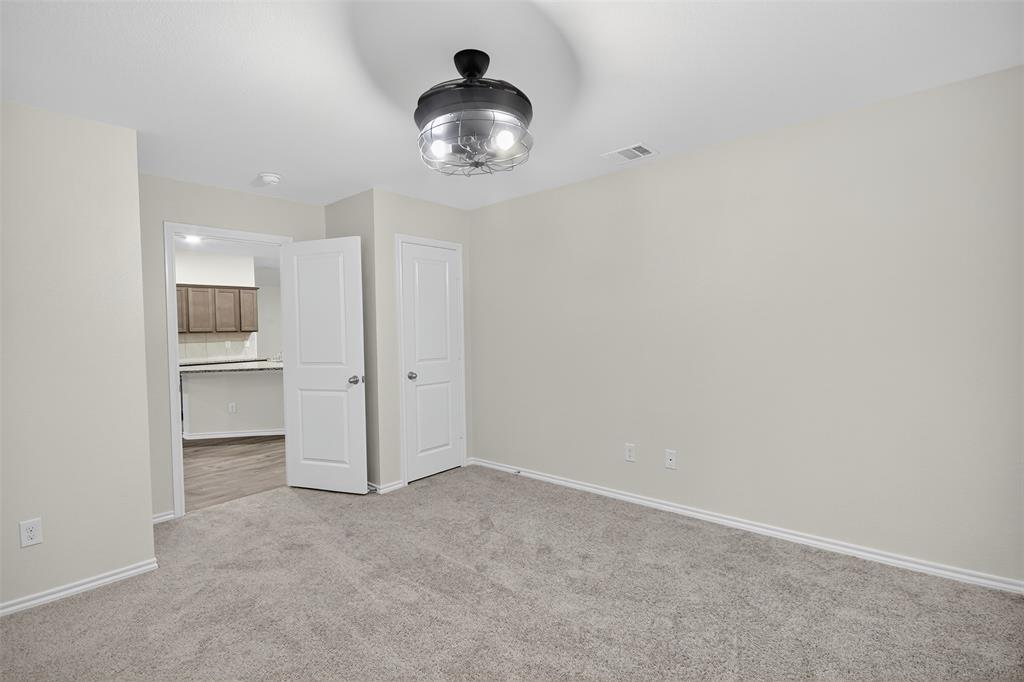 827 Rustic Way Royse City, TX 75189 - Photo 22 of 32 an empty room with a empty space and wooden floor