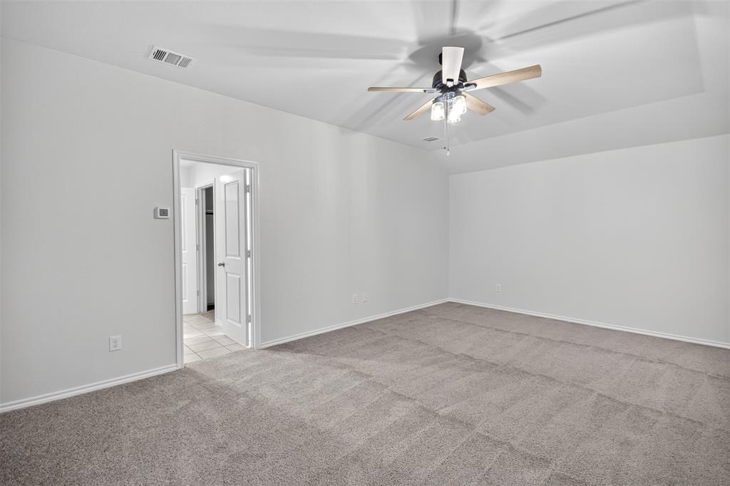 827 Rustic Way Royse City, TX 75189 - Photo 27 of 32 an empty room with a fan and a ceiling fan