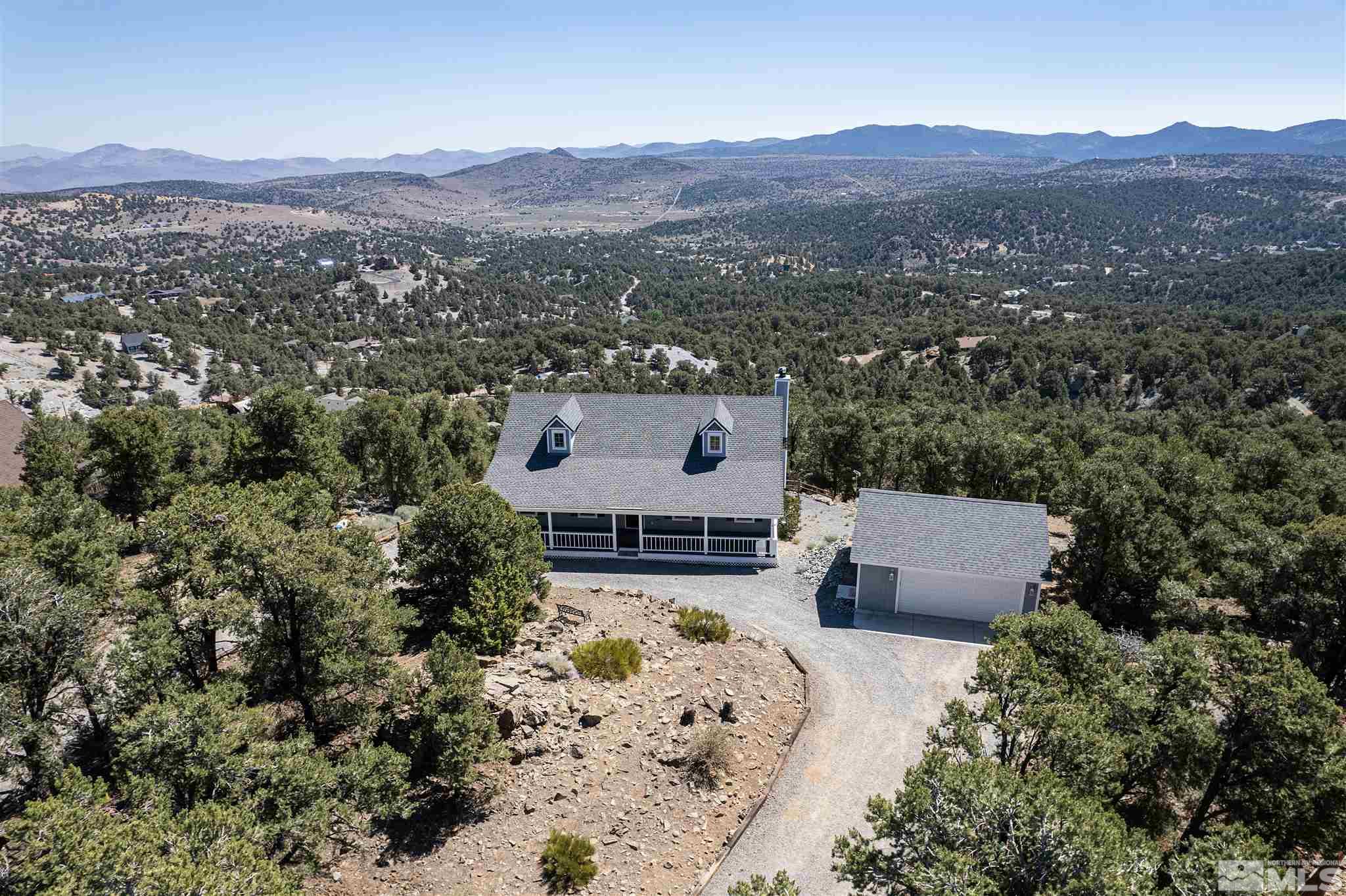 an aerial view of a house with a mountain view