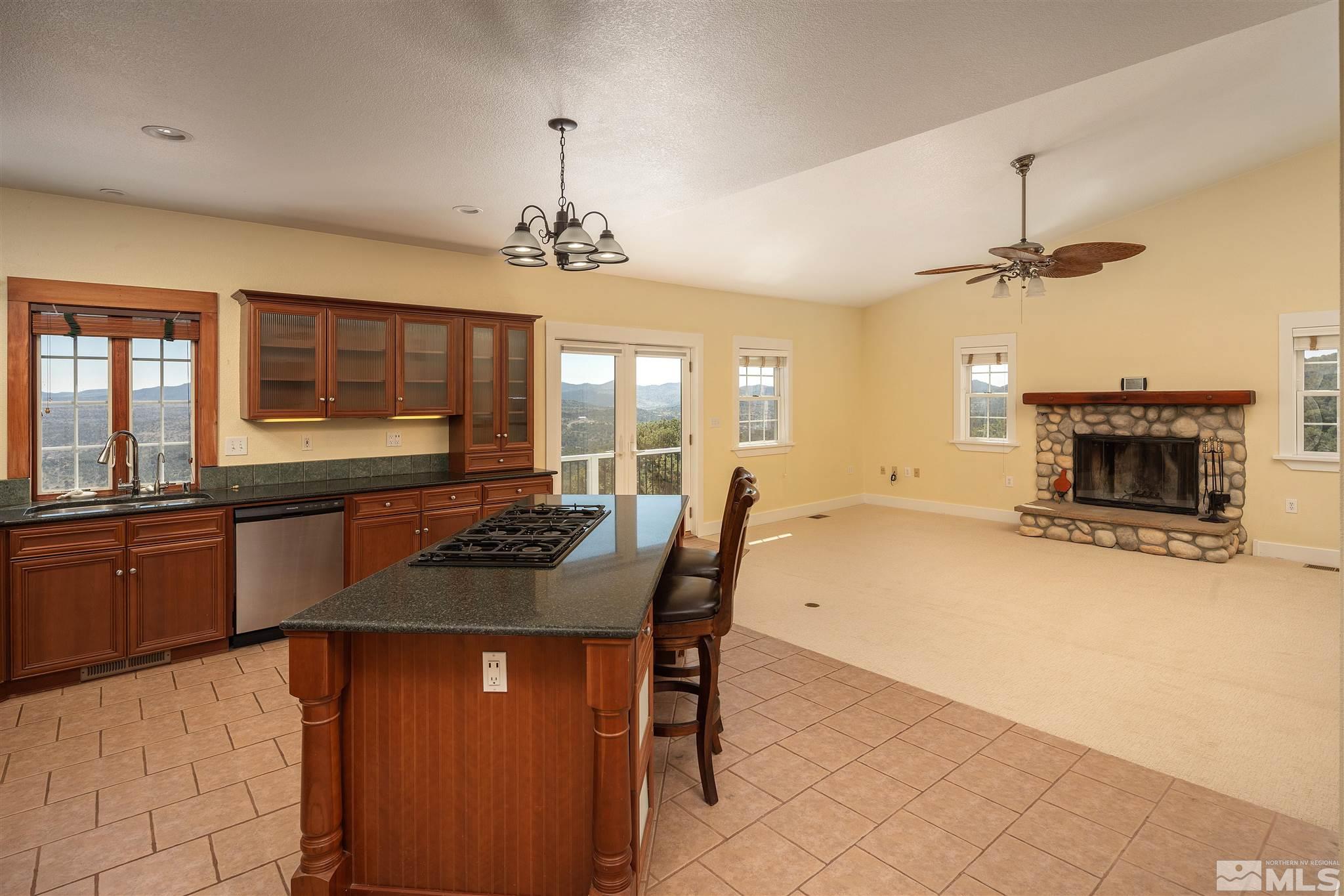 2035 Applegate Road Reno, NV 89521 - Photo 18 of 40 a kitchen with a chandelier dining table and chairs
