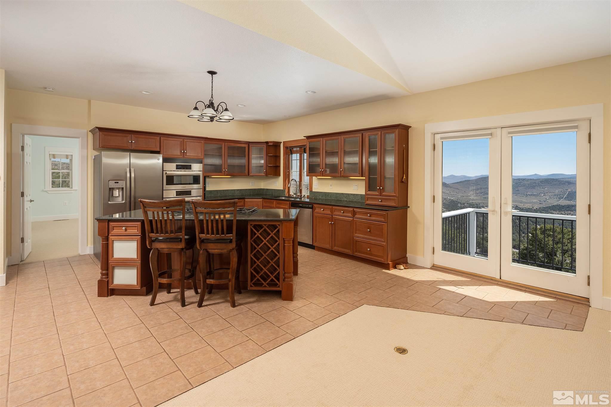 2035 Applegate Road Reno, NV 89521 - Photo 19 of 40 a open kitchen with stainless steel appliances kitchen island granite countertop a refrigerator and cabinets