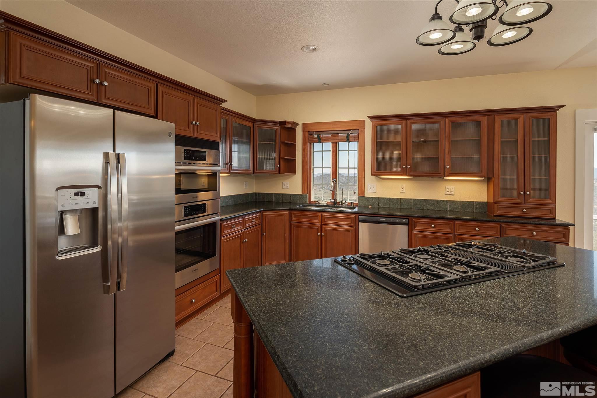 2035 Applegate Road Reno, NV 89521 - Photo 21 of 40 a kitchen with stainless steel appliances granite countertop a stove refrigerator sink and dishwasher