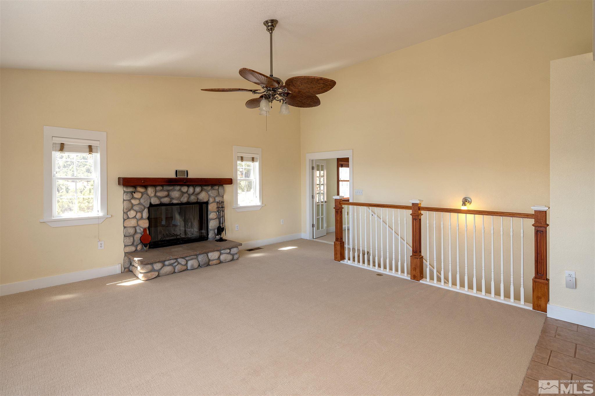 2035 Applegate Road Reno, NV 89521 - Photo 22 of 40 a view of empty room with fireplace and fan