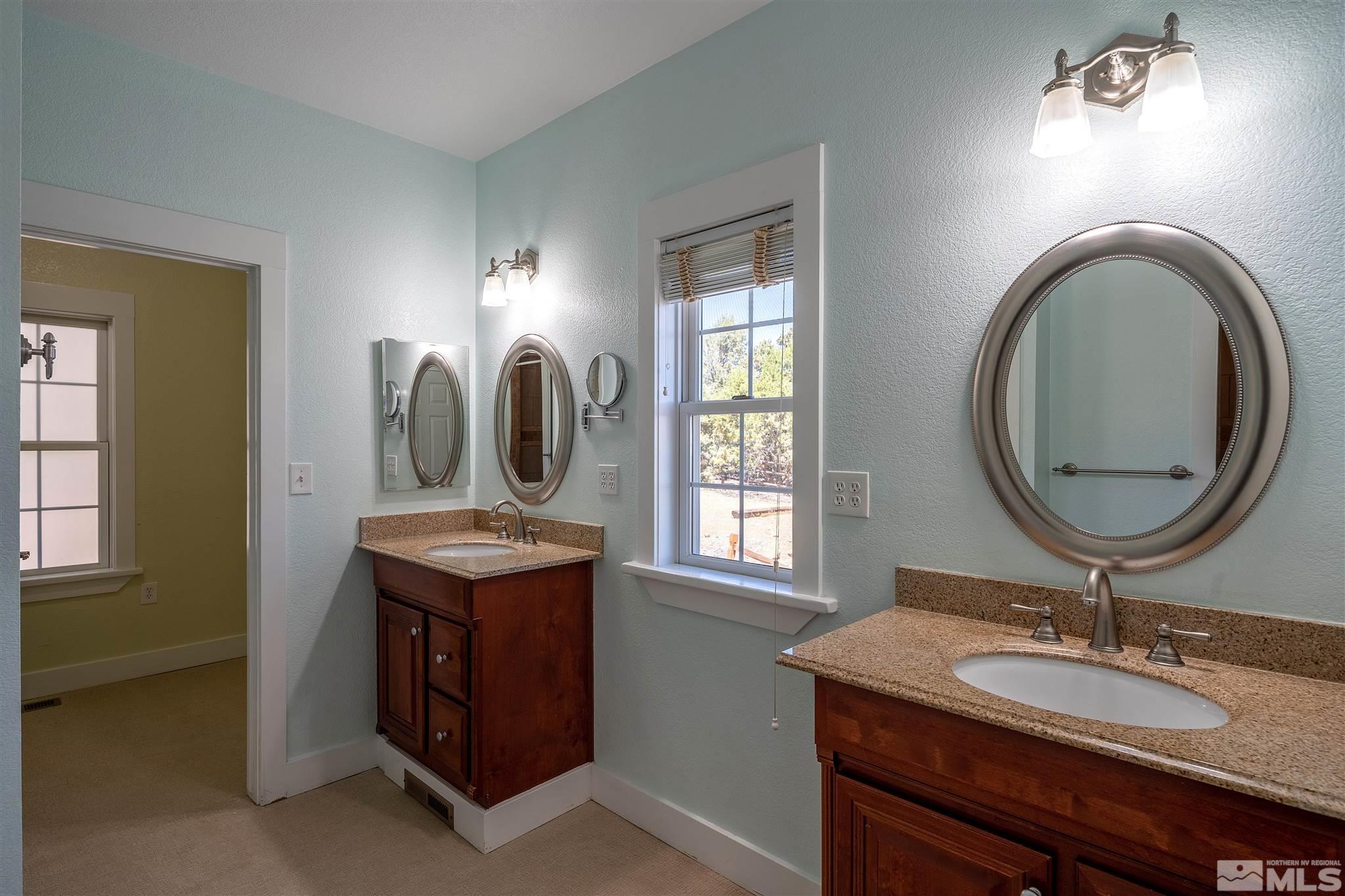 2035 Applegate Road Reno, NV 89521 - Photo 29 of 40 a bathroom with a granite countertop double vanity sink and a mirror