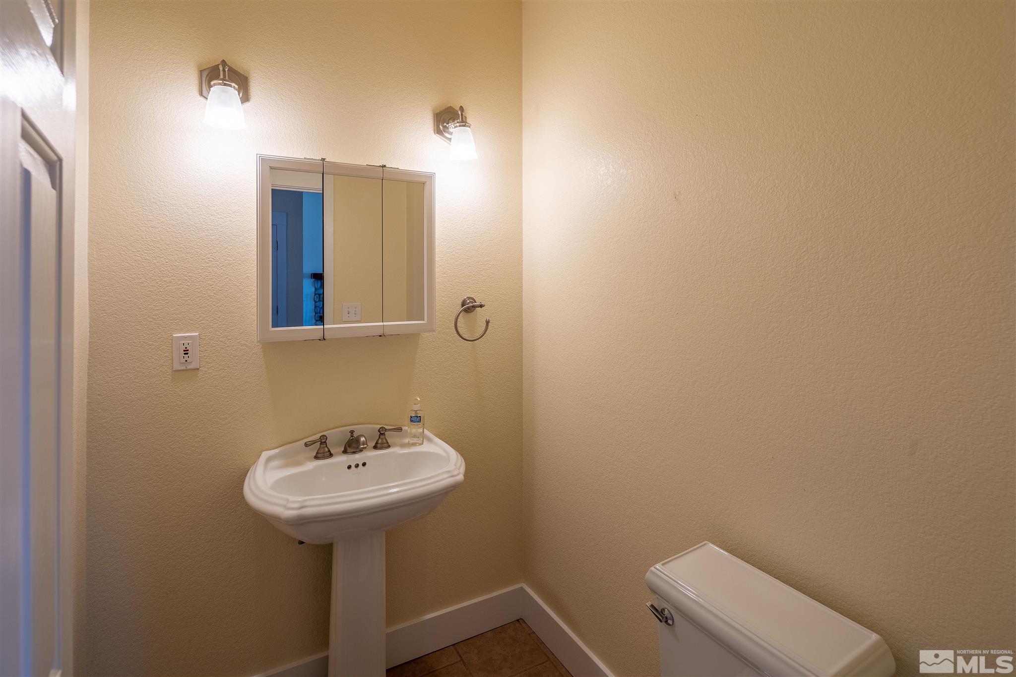 2035 Applegate Road Reno, NV 89521 - Photo 37 of 40 a bathroom with a sink a mirror and a toilet