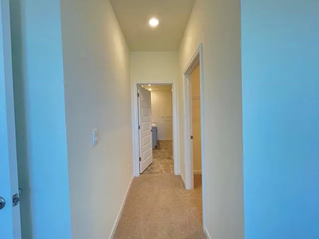 a view of a hallway with wooden shelves