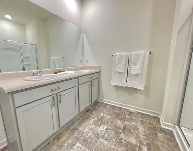 a spacious bathroom with a sink and a mirror