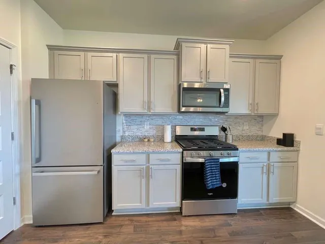 a kitchen with a stove microwave and refrigerator