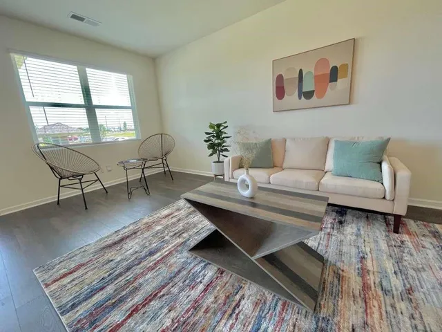 a living room with furniture and a window