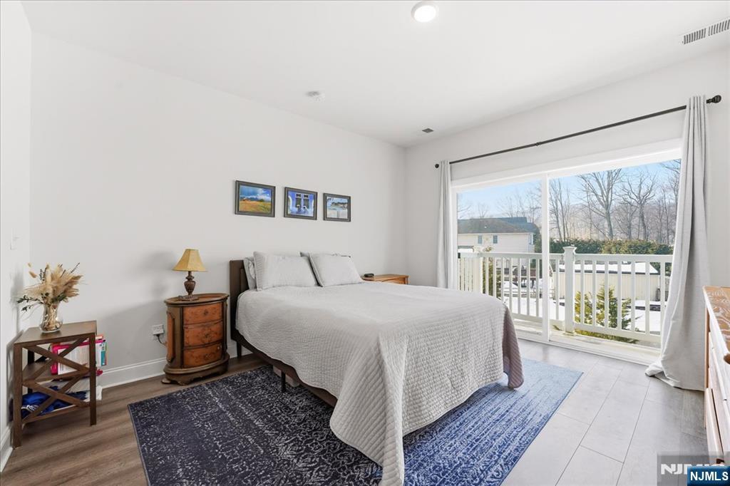 905 Abbe Road Little Falls, NJ 07424 - Photo 11 of 26 a bedroom with a large bed and a large window