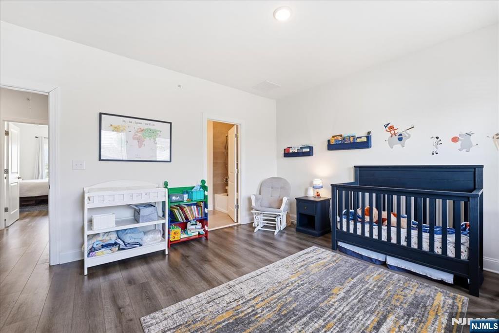 905 Abbe Road Little Falls, NJ 07424 - Photo 18 of 26 a bedroom with furniture and a wooden floor