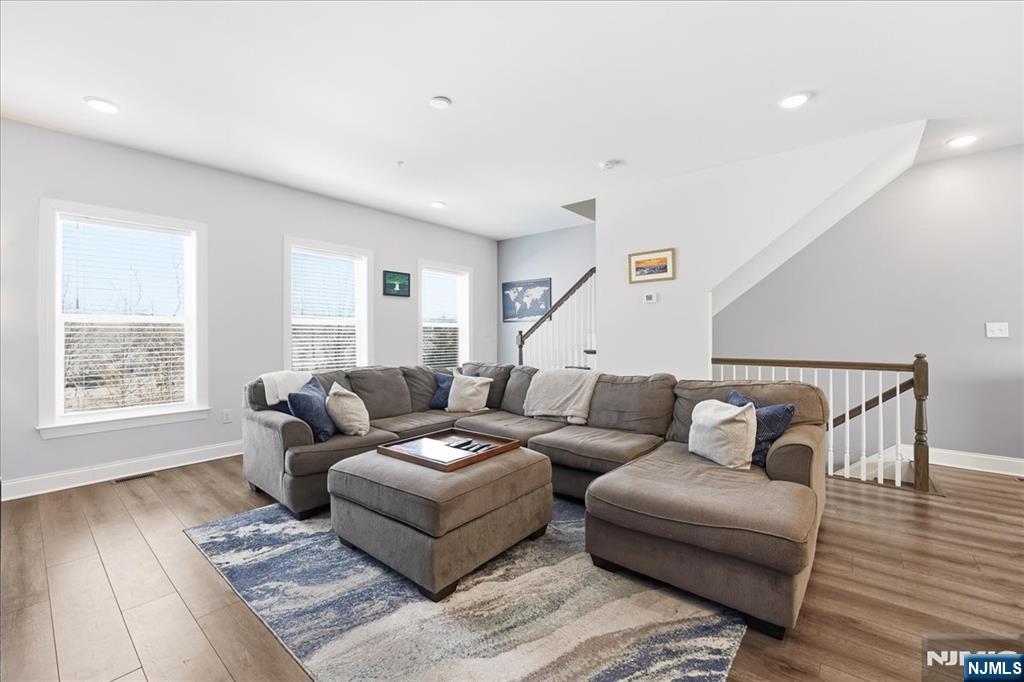905 Abbe Road Little Falls, NJ 07424 - Photo 3 of 26 a living room with furniture and wooden floor