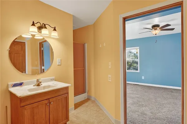 a bathroom with a sink a mirror and a vanity