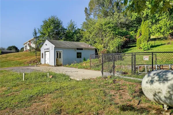 a view of a house with backyard and sitting area