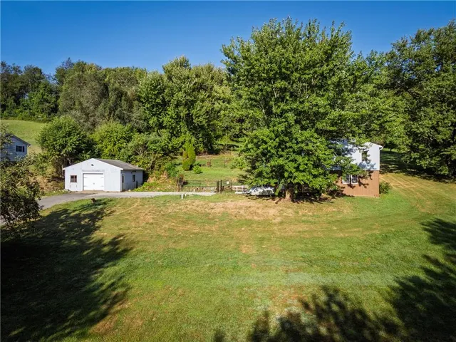 a view of a houses with yard and lake view