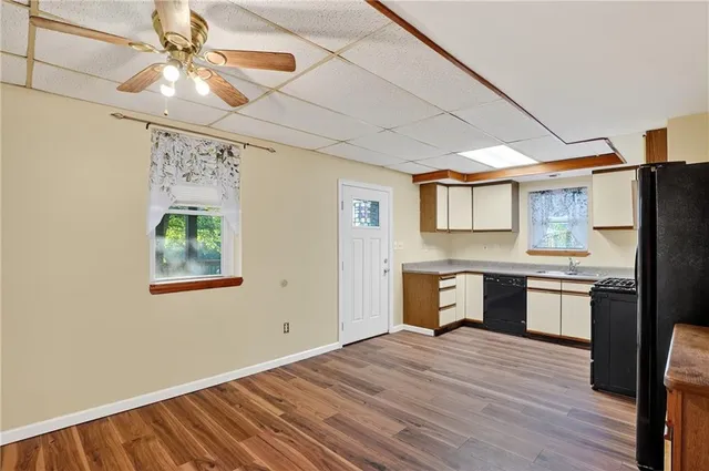 a kitchen with a refrigerator and a stove top oven