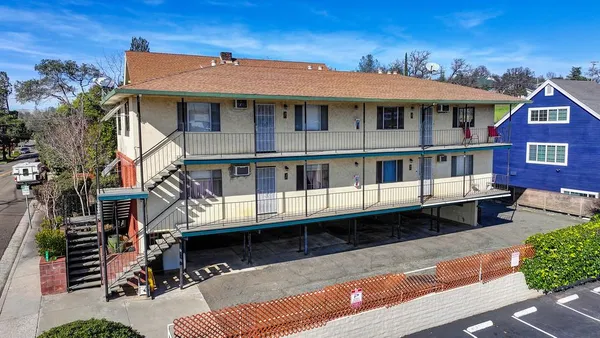 a view of a white building among the front of house
