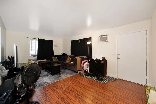a living room with furniture flat screen tv and a lamp