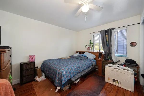 a bedroom with a bed and a chandelier