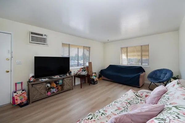 a bedroom with furniture and a flat screen tv