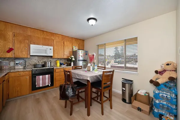a kitchen with a table chairs sink and cabinets