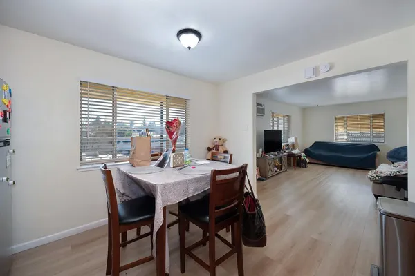 a view of a dining room with furniture and a large window