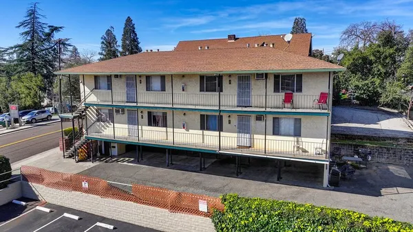 a front view of a house with yard and balcony