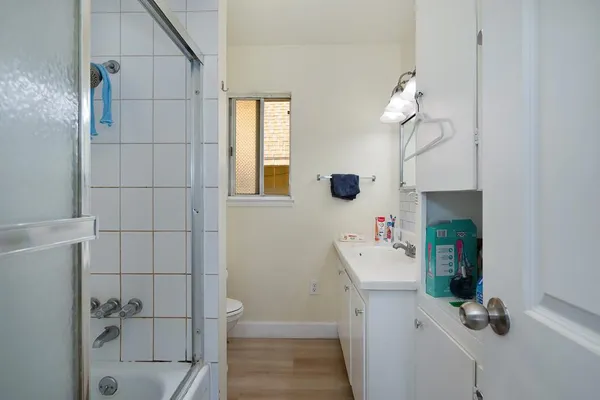 a bathroom with a sink a toilet and shower