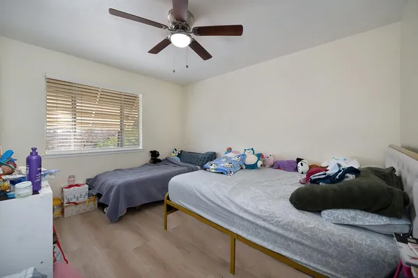 a bedroom with a bed and a chandelier