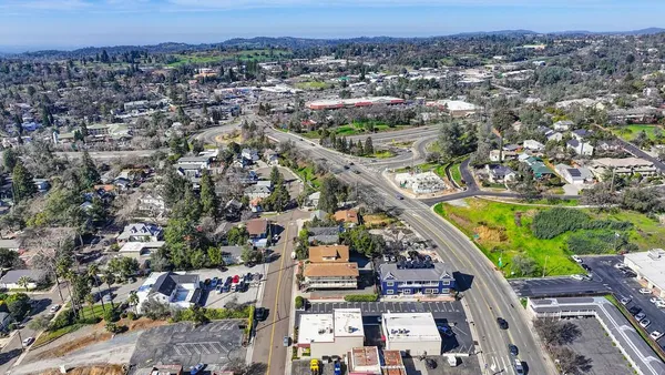 an aerial view of a house with a garden and mountain view