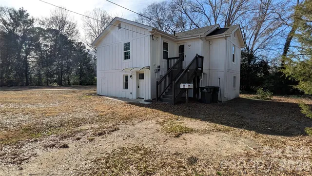 a view of a house with snow on the road