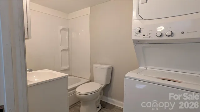 a white toilet sitting next to a bathroom sink