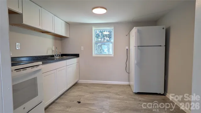 a kitchen with a refrigerator and a stove