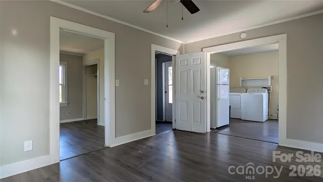 a view of a hallway with wooden floor and closet
