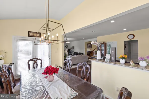 a view of a room that has a large window and furniture