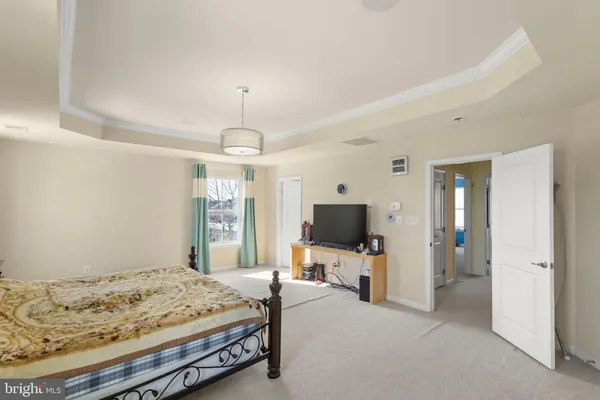 a bedroom with a bed and flat tv screen