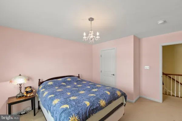 a bed room with a bed and a chandelier