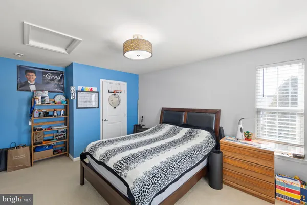 a bedroom with a bed and a book shelf